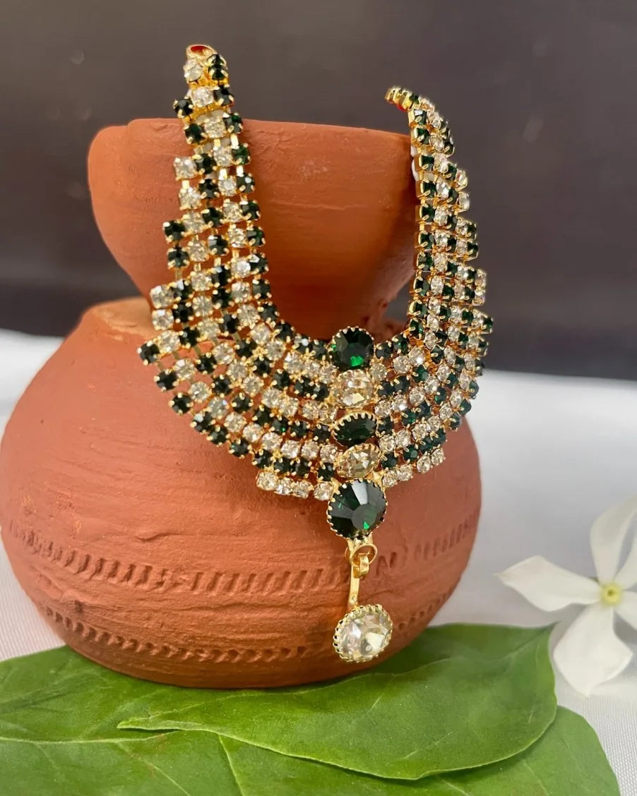Laddu Gopal 4-layer green and white stone jewellery haar placed on terracotta pot with leaves and white flower.