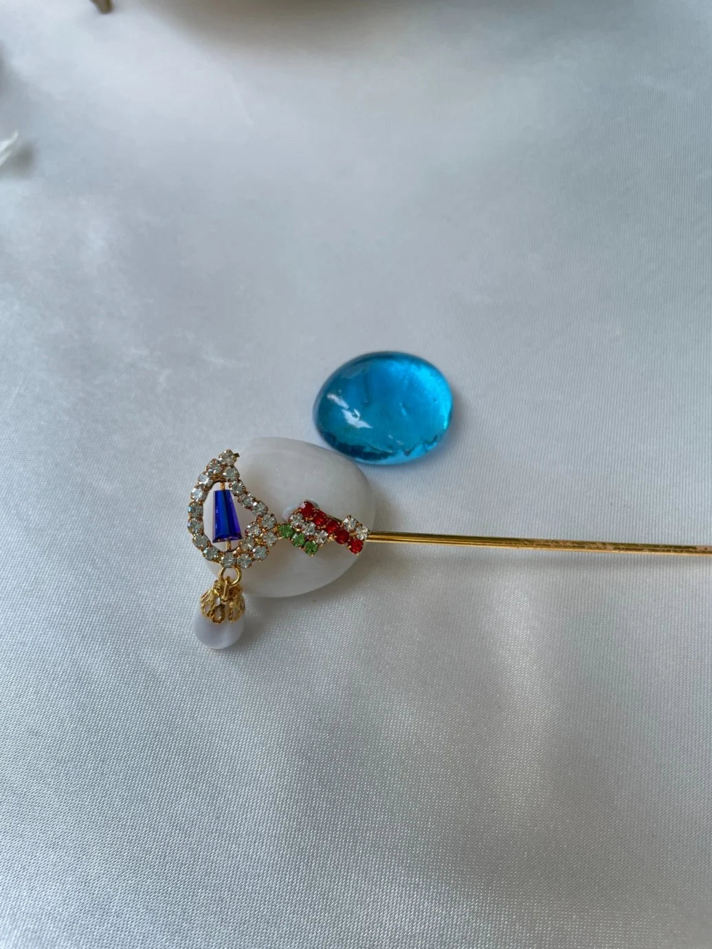 Laddu Gopal bansuri with multicolored crystals and blue stone, pearl hanging – elegant flute for Bal Gopal shringar.