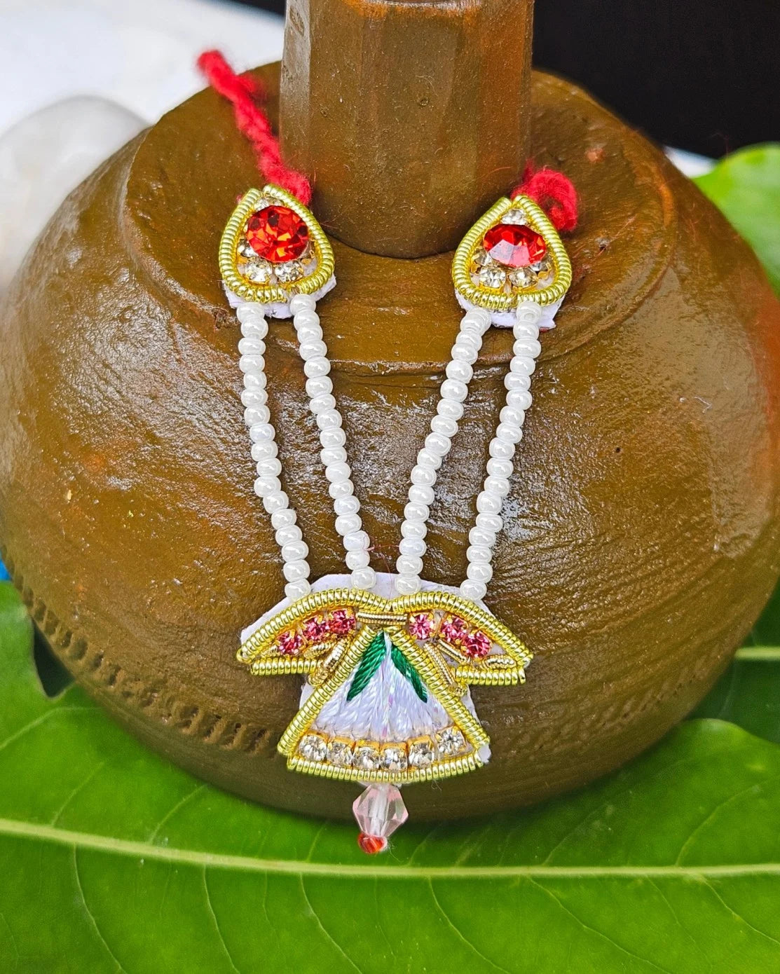 Laddu Gopal red green feather mukut with white bead mala – crown and necklace set for Krishna shringar.