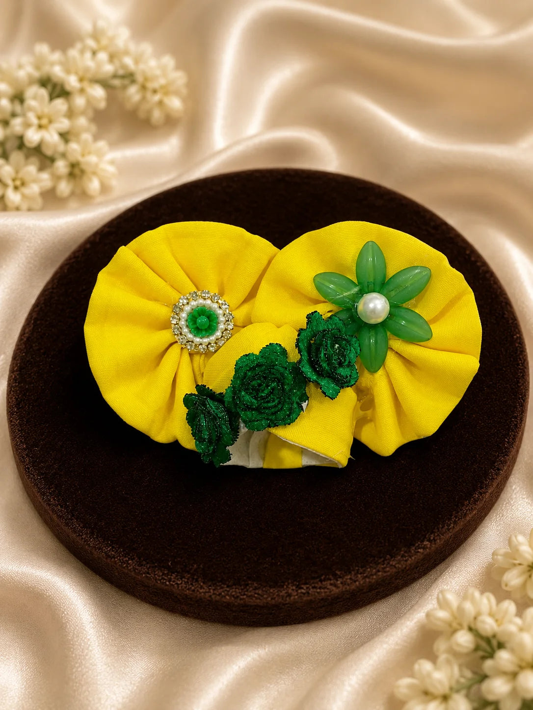 Black stone Laddu Gopal Ji idol adorned in a premium bright yellow dress with green leaf embroidery, sparkling stone work, and a matching heavy yellow turban decorated with green fabric roses