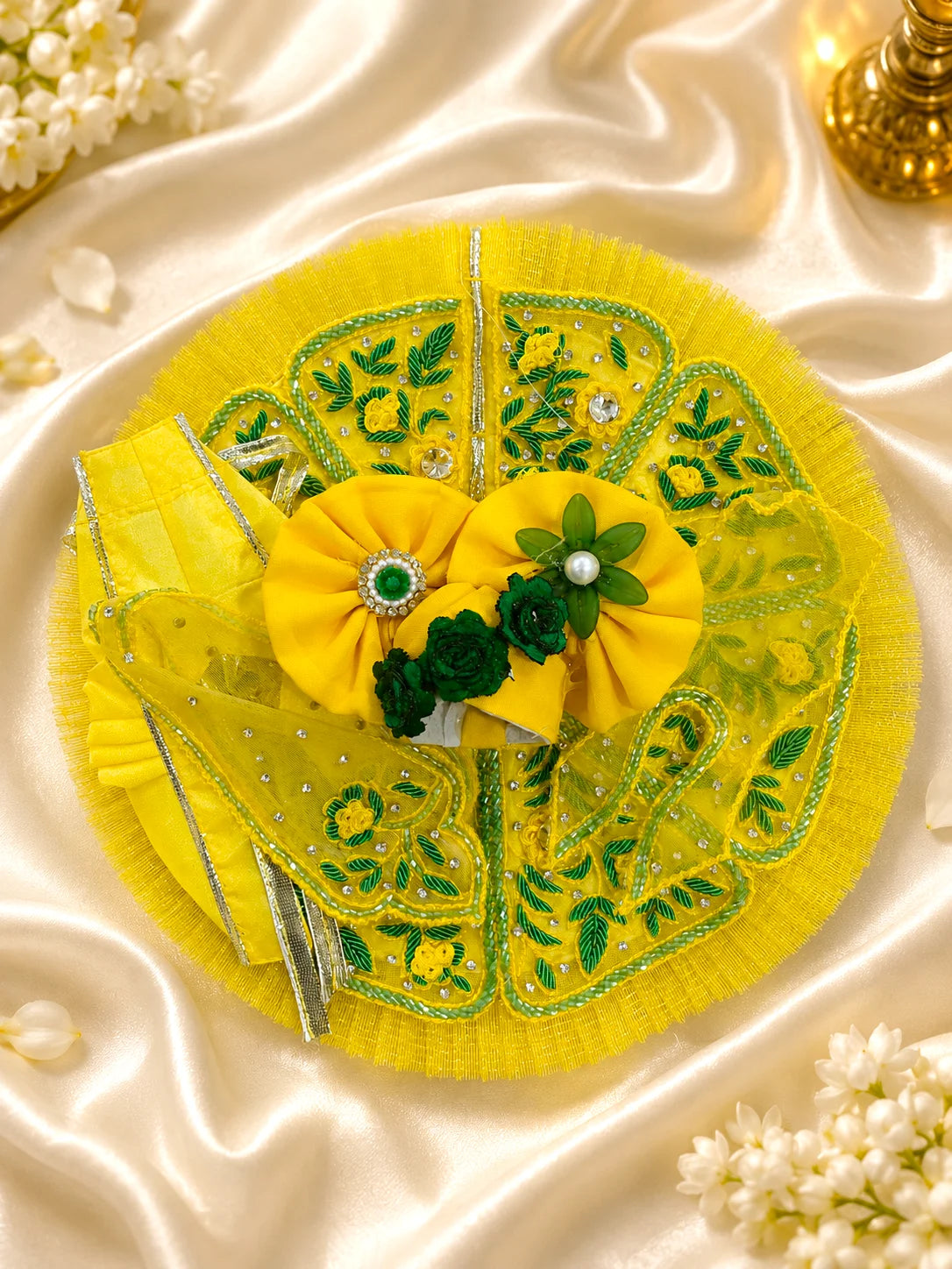 Black stone Laddu Gopal Ji idol adorned in a premium bright yellow dress with green leaf embroidery, sparkling stone work, and a matching heavy yellow turban decorated with green fabric roses