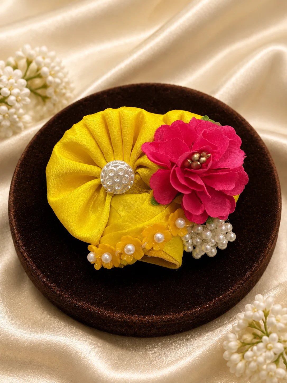 Black stone Laddu Gopal Ji idol wearing a premium yellow double-layered dress with multi-color magenta and orange floral embroidery, silver scalloped lace, and a matching yellow turban decorated with a heavy magenta fabric rose