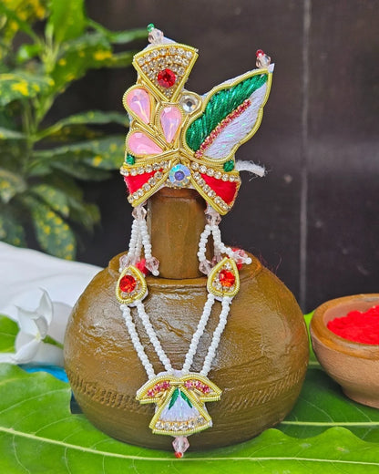 Laddu Gopal red green feather mukut with white bead mala – crown and necklace set for Krishna shringar.