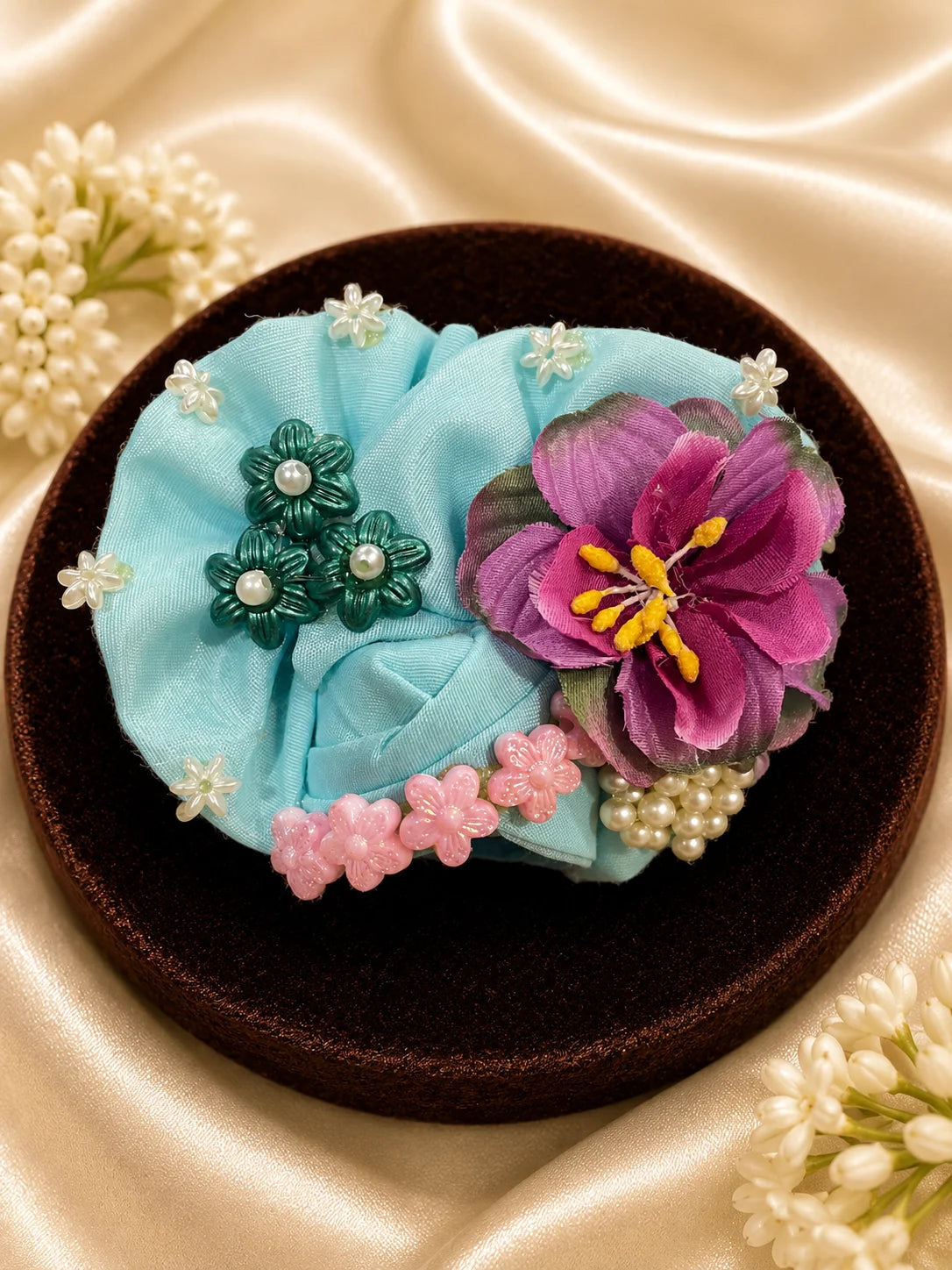 Close-up view of a mint green Laddu Gopal poshak featuring highly detailed embroidery of a white swan, pink lotus flowers, green lily pads, and a scalloped brown border with light green mesh frill&nbsp;