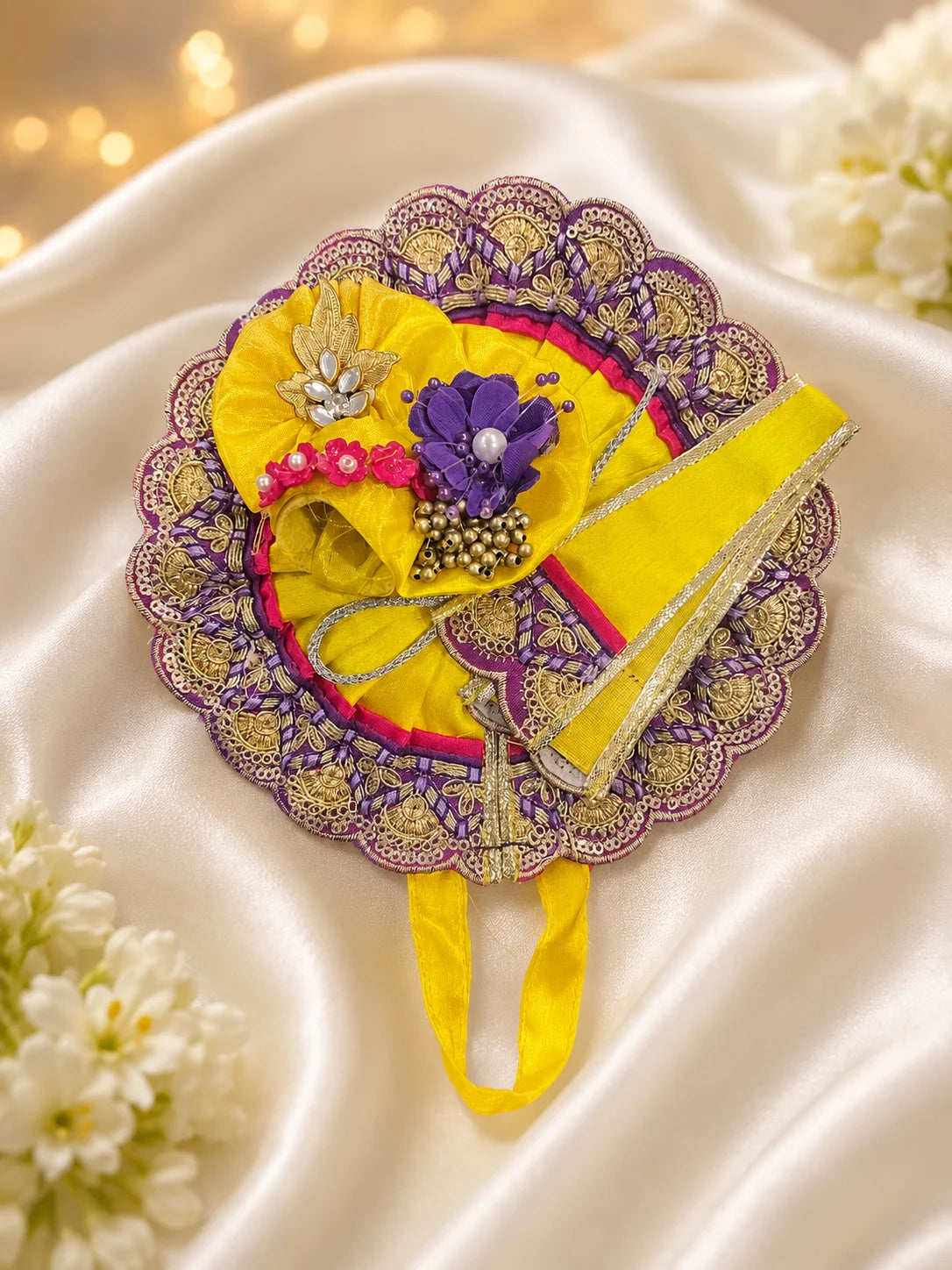 Close Up of Purple Scalloped Metallic Zari Lace on Magenta and Yellow Pleated Laddu Gopal Dress
