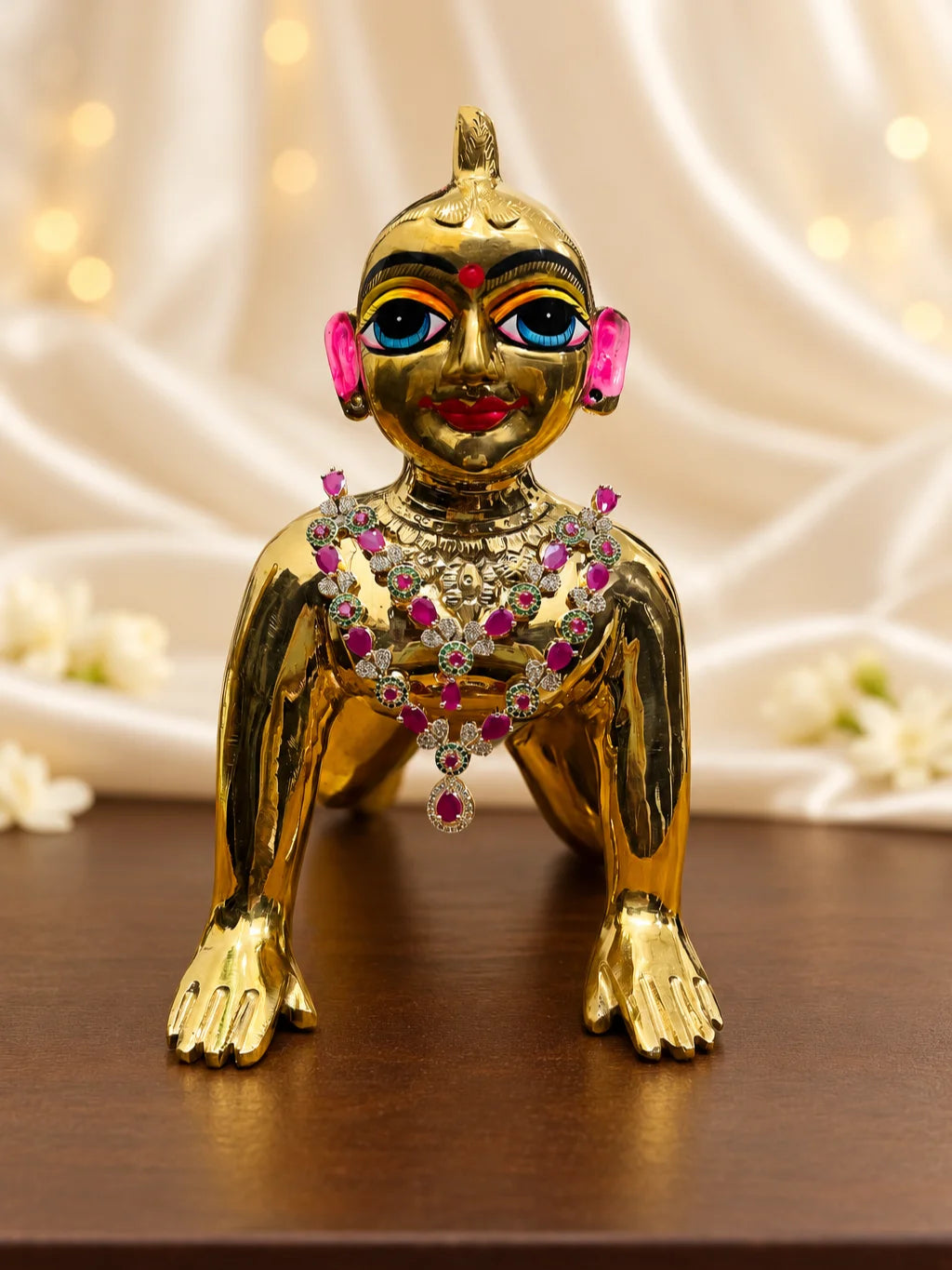 Shop Manikya Ratnamala AD Necklace for Deity with ruby-inspired accents and sparkling AD work. A regal jewellery piece for Laddu Gopal and festive shringar.
