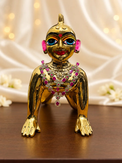 Shop Manikya Ratnamala AD Necklace for Deity with ruby-inspired accents and sparkling AD work. A regal jewellery piece for Laddu Gopal and festive shringar.
