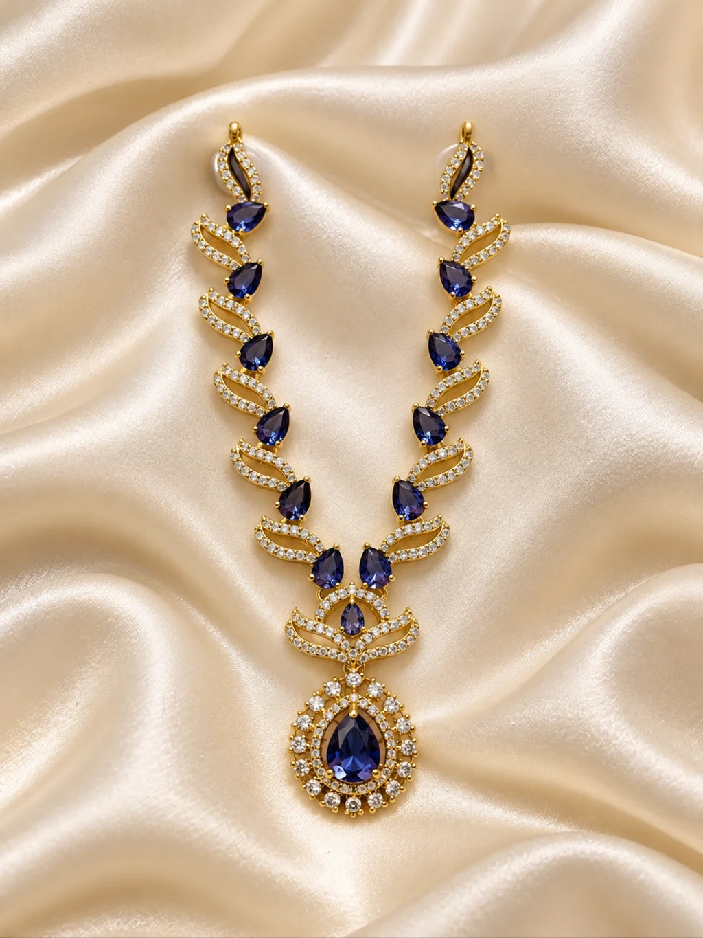 Manikya Tarang AD Necklace for Deity with ruby-inspired accents, flowing wave-style design and sparkling American Diamond detailing

