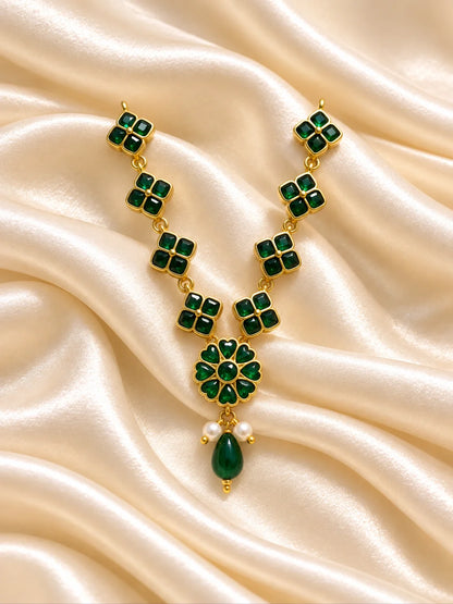 Panna Kusum Necklace and Bansuri Set for Deity featuring emerald-green inspired floral jewellery and a matching decorative Krishna flute for Laddu Gopal shringar
