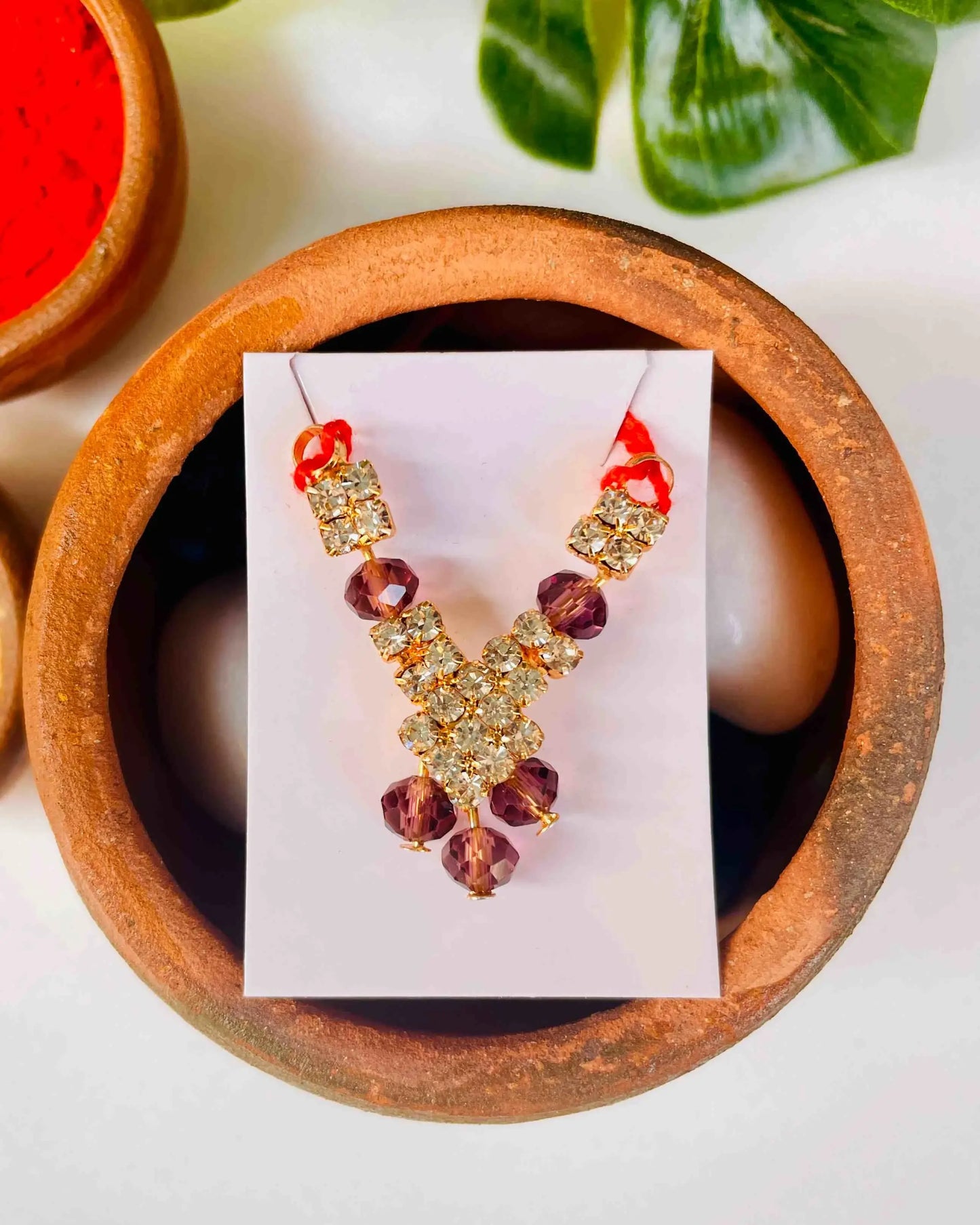 Laddu Gopal jewellery with golden stones and purple crystal beads for Kanha Ji.
