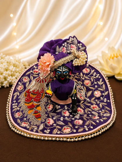 Royal purple Laddu Gopal dress set with detailed silver embroidery, embroidered peacock motif, pearl border, matching patka, and pink flower pagdi turban on white silk fabric