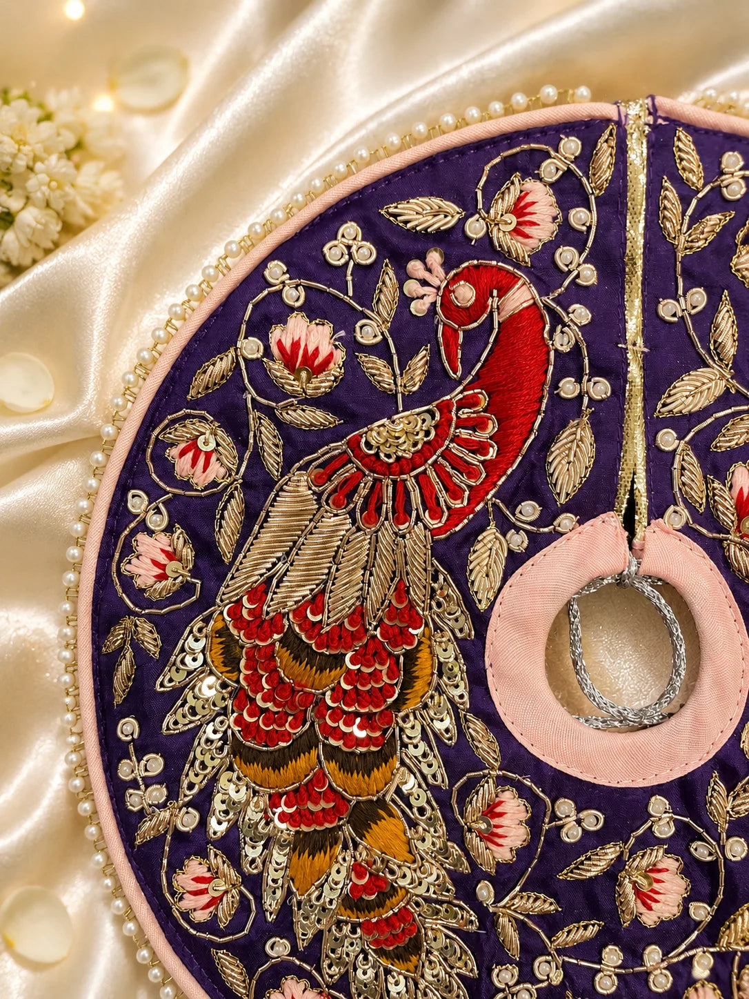 Royal purple Laddu Gopal dress set with detailed silver embroidery, embroidered peacock motif, pearl border, matching patka, and pink flower pagdi turban on white silk fabric