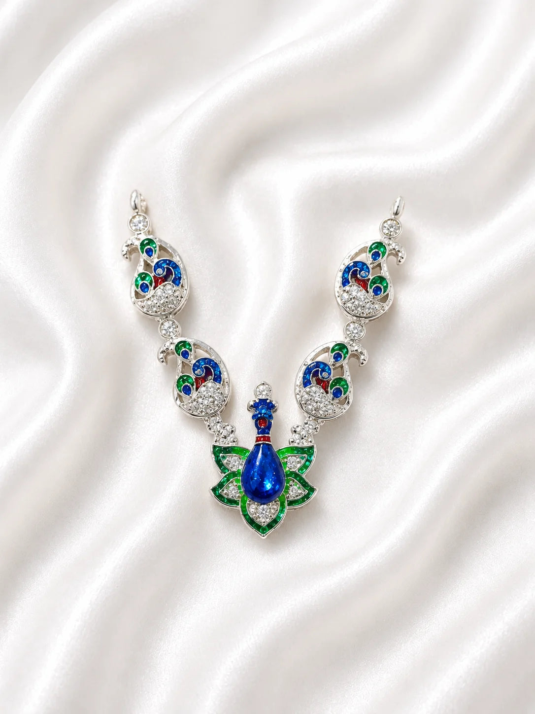 Sacred silver finish blue and green Meenakari peacock necklace for deity shringar on white fabric