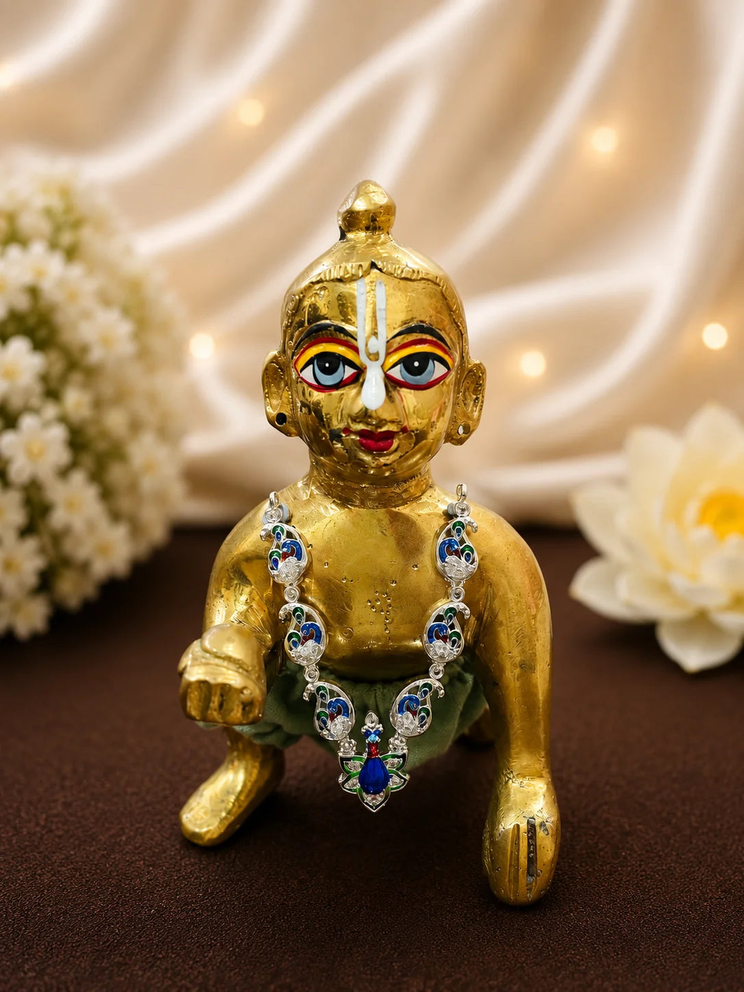 Traditional blue and green enamel peacock shringar necklace worn by a brass Laddu Gopal Ji idol