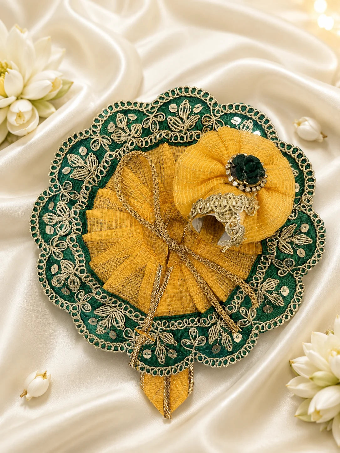 Close Up of Emerald Green Scalloped Metallic Zari Lace and Sequins on Yellow Textured Laddu Gopal Dress

