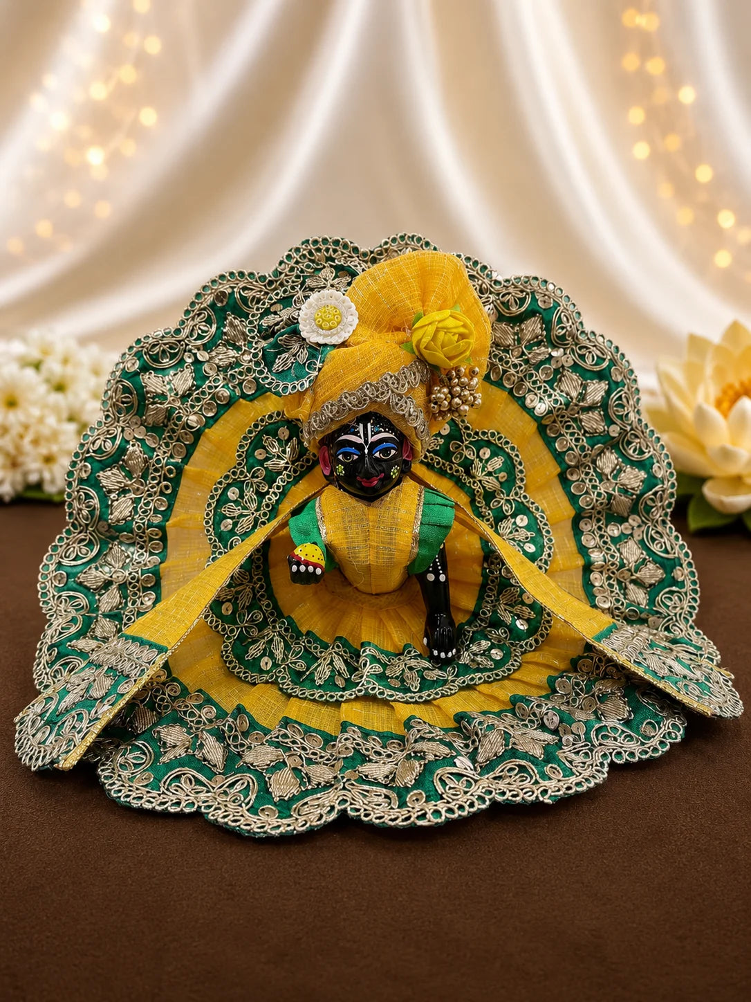 Close Up of Emerald Green Scalloped Metallic Zari Lace and Sequins on Yellow Textured Laddu Gopal Dress

