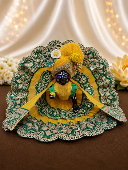 Close Up of Emerald Green Scalloped Metallic Zari Lace and Sequins on Yellow Textured Laddu Gopal Dress


