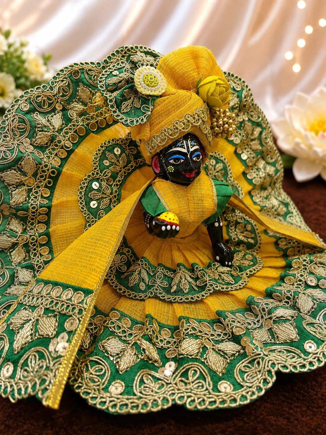 Deity Wearing Regal Green and Yellow Scalloped Zari Border Laddu Gopal Poshak with Heavy Rose Flower Pagdi