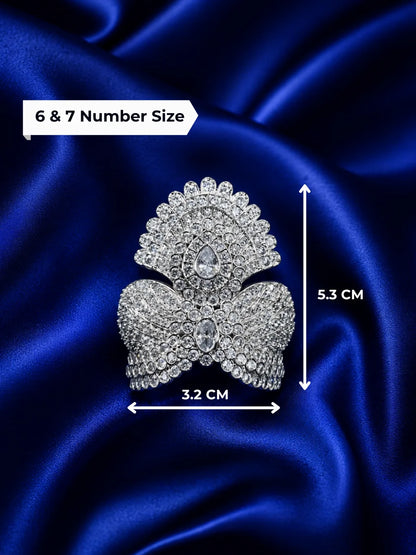 remium silver plated Jadau American Diamond mukut crown featuring intricate all-white crystal settings on a rich royal blue satin fabric