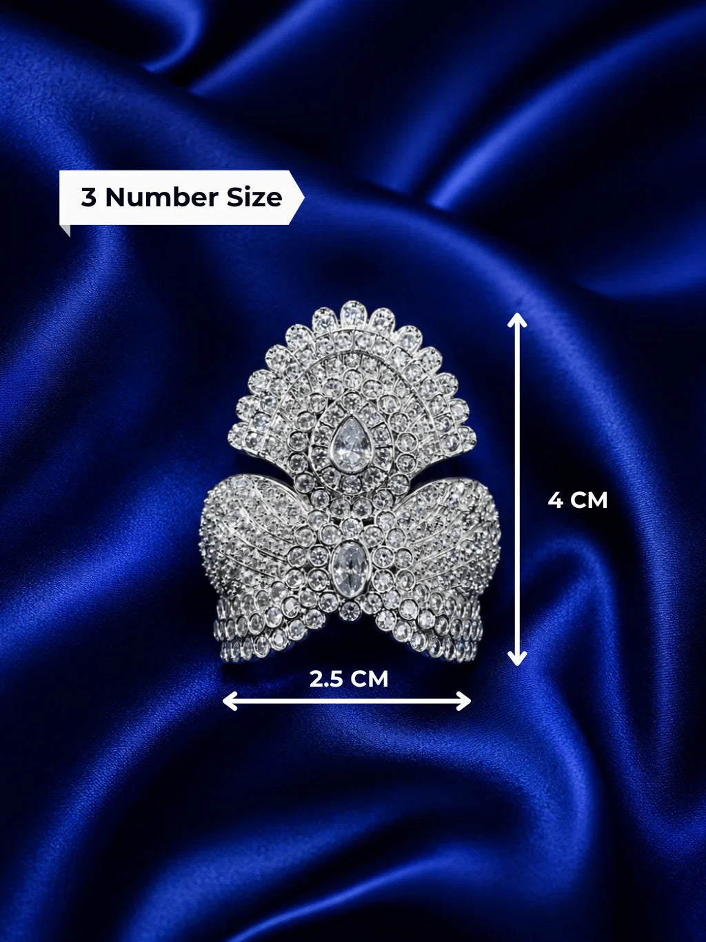 remium silver plated Jadau American Diamond mukut crown featuring intricate all-white crystal settings on a rich royal blue satin fabric