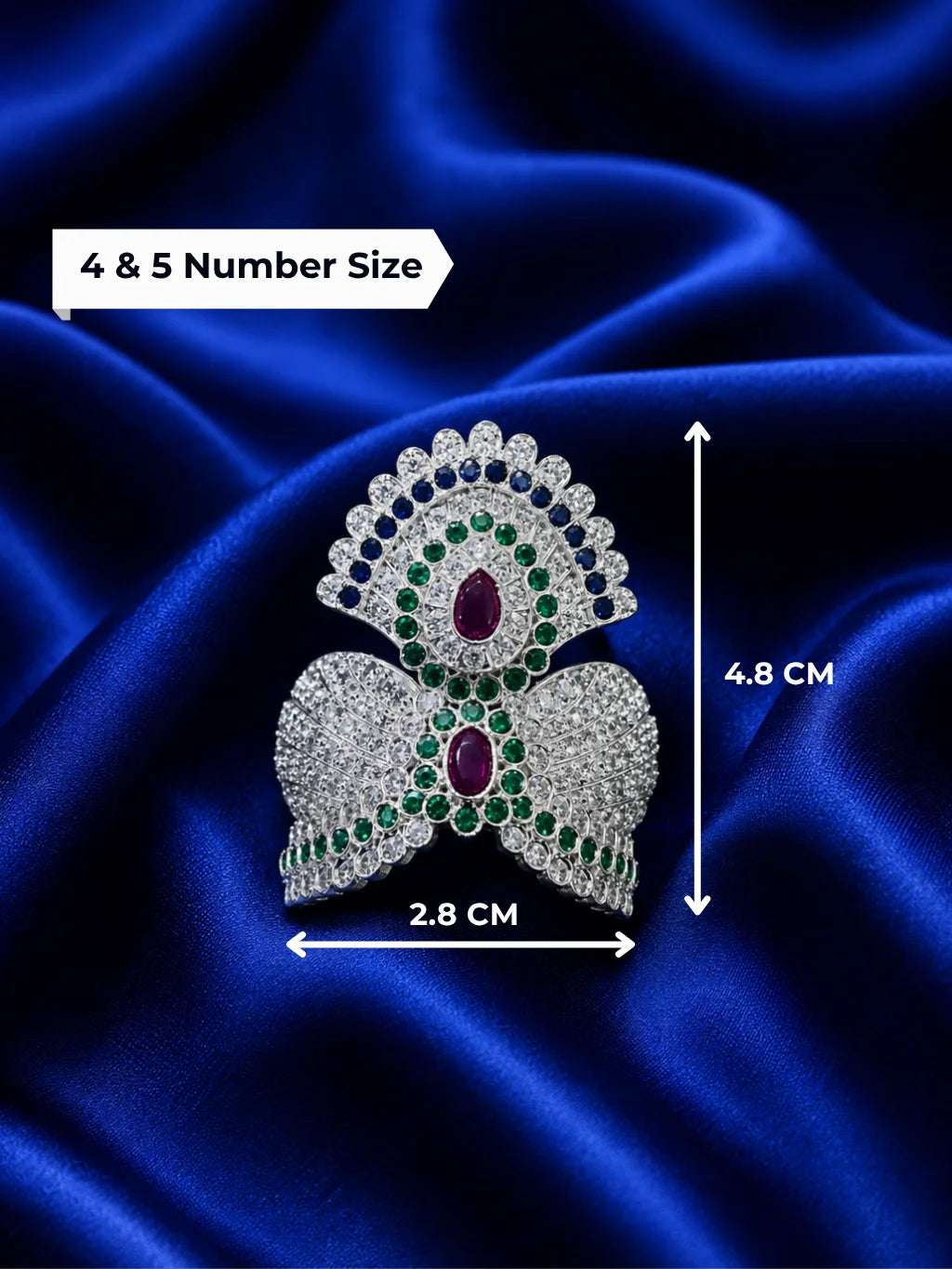 remium silver plated Jadau American Diamond mukut crown featuring intricate all-white crystal settings on a rich royal blue satin fabric