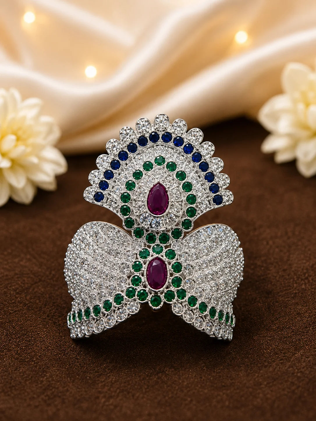 Black brass Laddu Gopal idol adorned with a majestic all-white sparkling diamond silver crown against a soft gold background