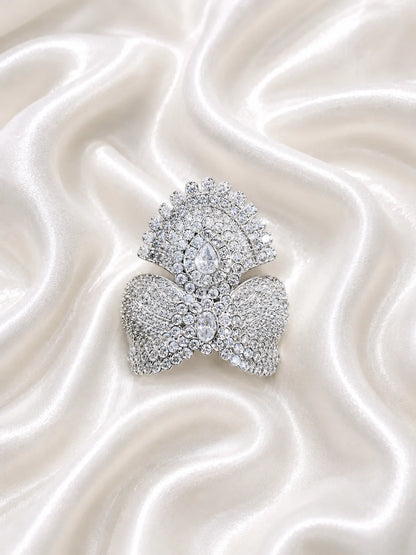 Black brass Laddu Gopal idol adorned with a majestic all-white sparkling diamond silver crown against a soft gold background