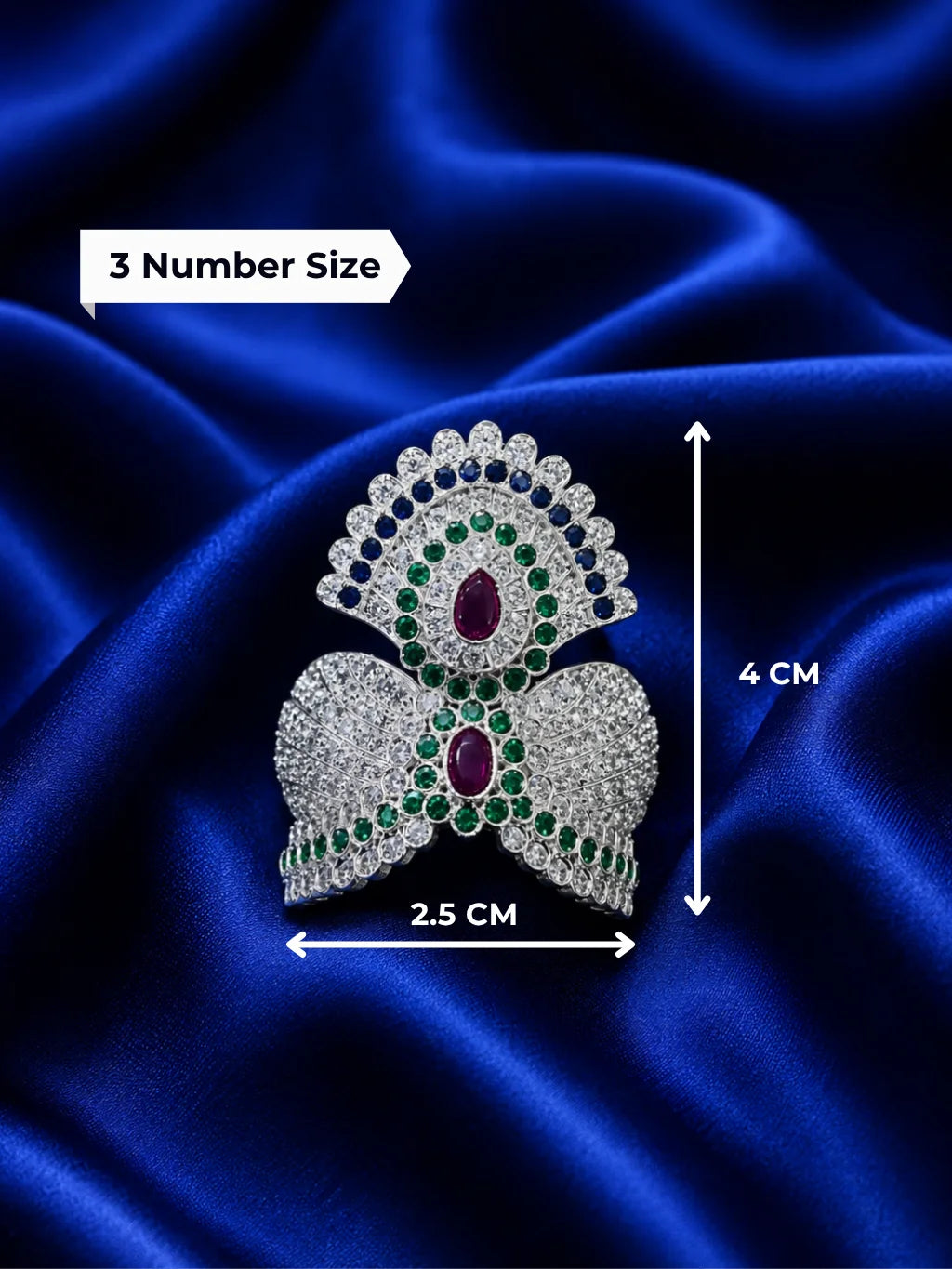 remium silver plated Jadau American Diamond mukut crown featuring intricate all-white crystal settings on a rich royal blue satin fabric
